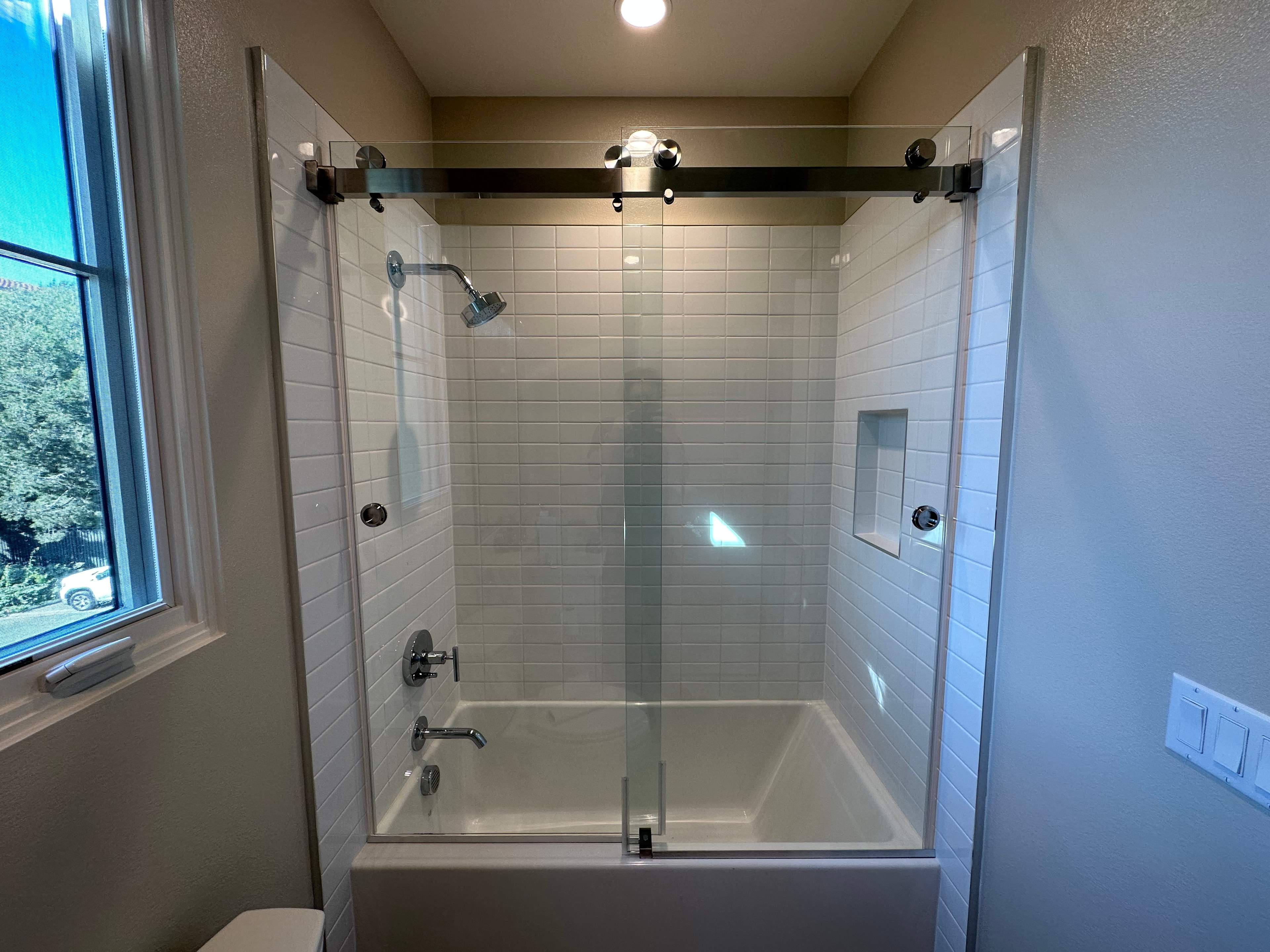 Frameless shower door and glass enclosure